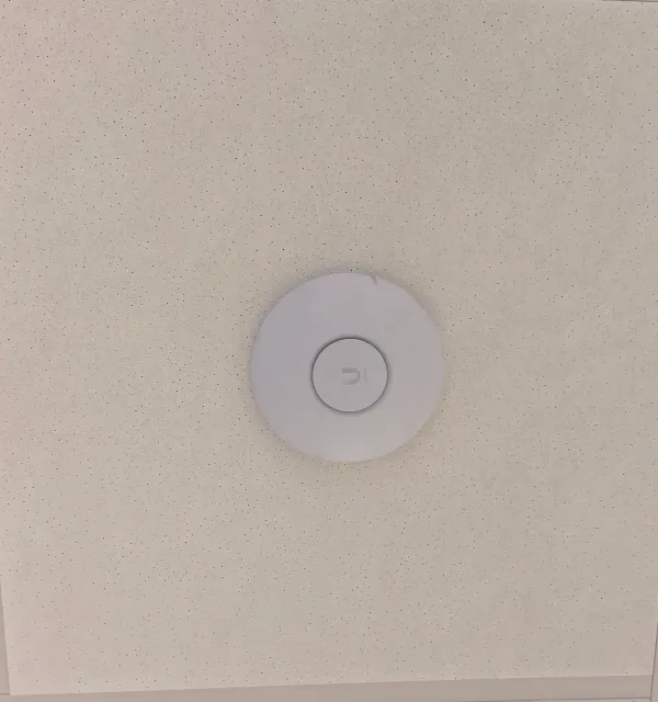 Ceiling-mounted UniFi access point installed by Sovun Technologies in Maine