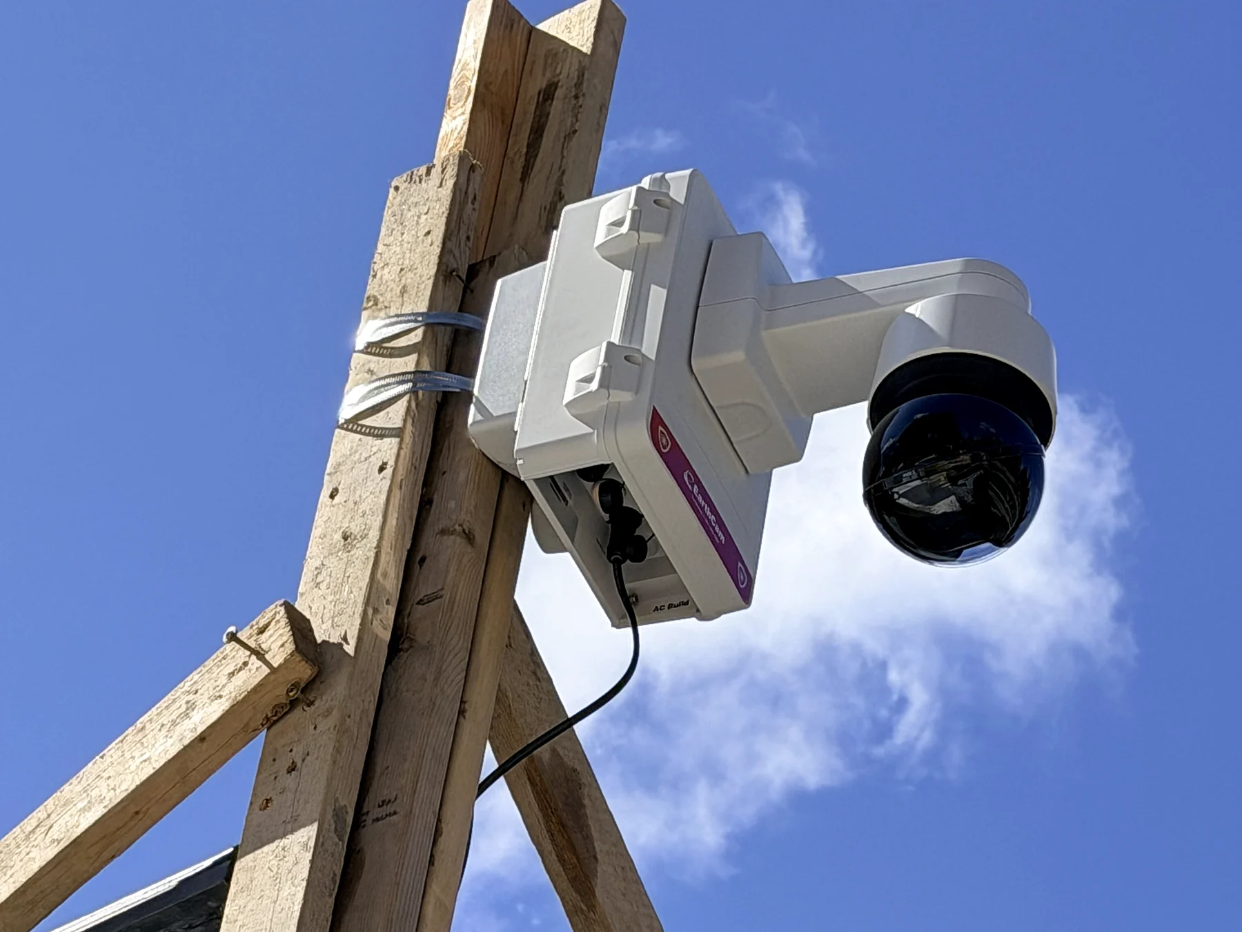 Pole-mounted security cameras with SECURITY signage at a Maine construction site