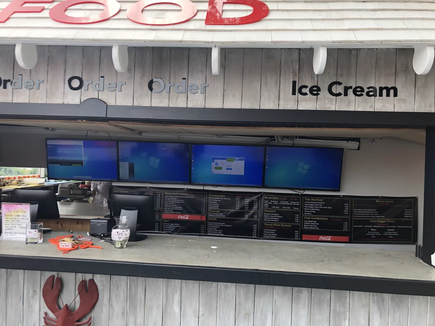 Outdoor menu display screens at a Maine restaurant stand
