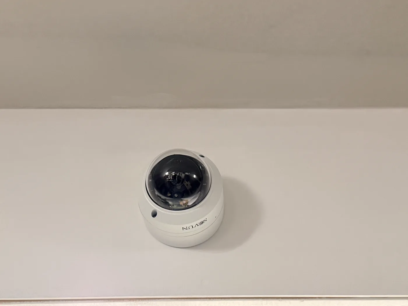 Dome security camera installed on an overhead beam in Maine