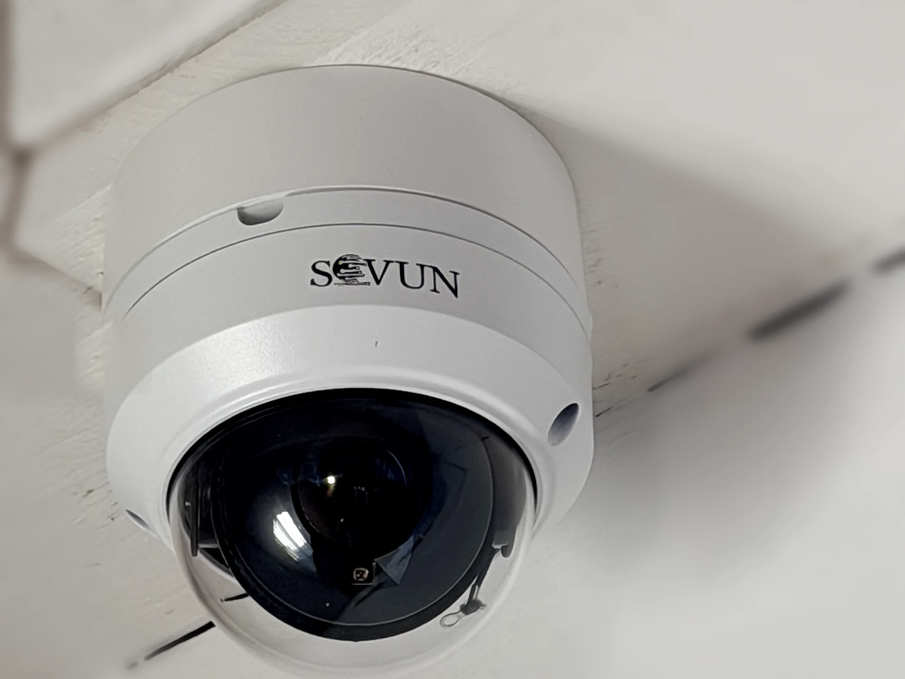 SOVUN-branded dome camera installed on a white ceiling beam